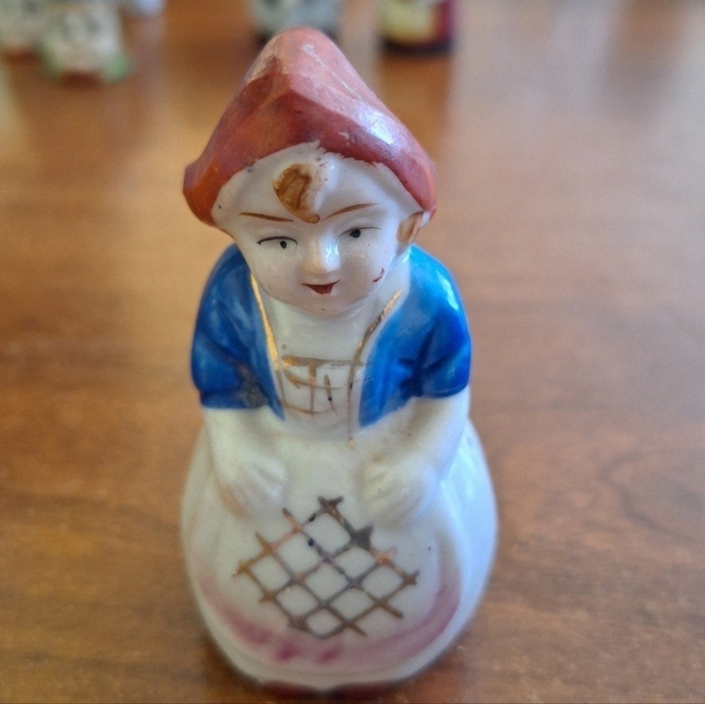 Charming Ceramic Figurine with Red and Blue Accents